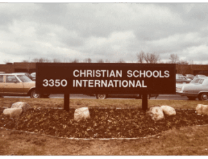 A photo of a sign featuring the new organization name, Christian Schools International.