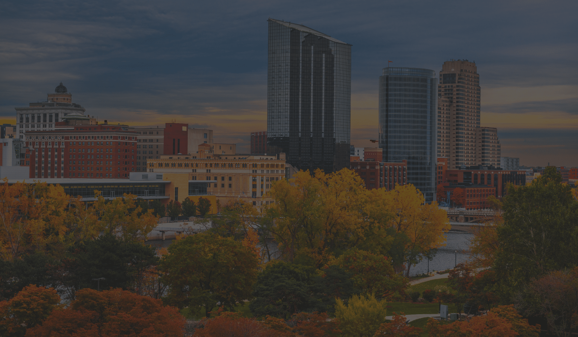 View of downtown Grand Rapids, Michigan with fall trees surrounding the Grand River.